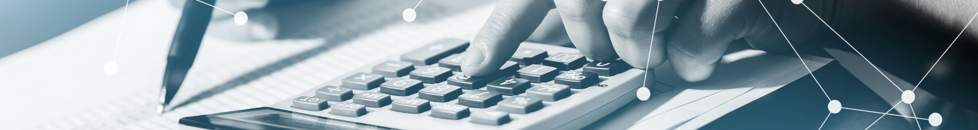Close up image of a person holding and pen and using a calculator